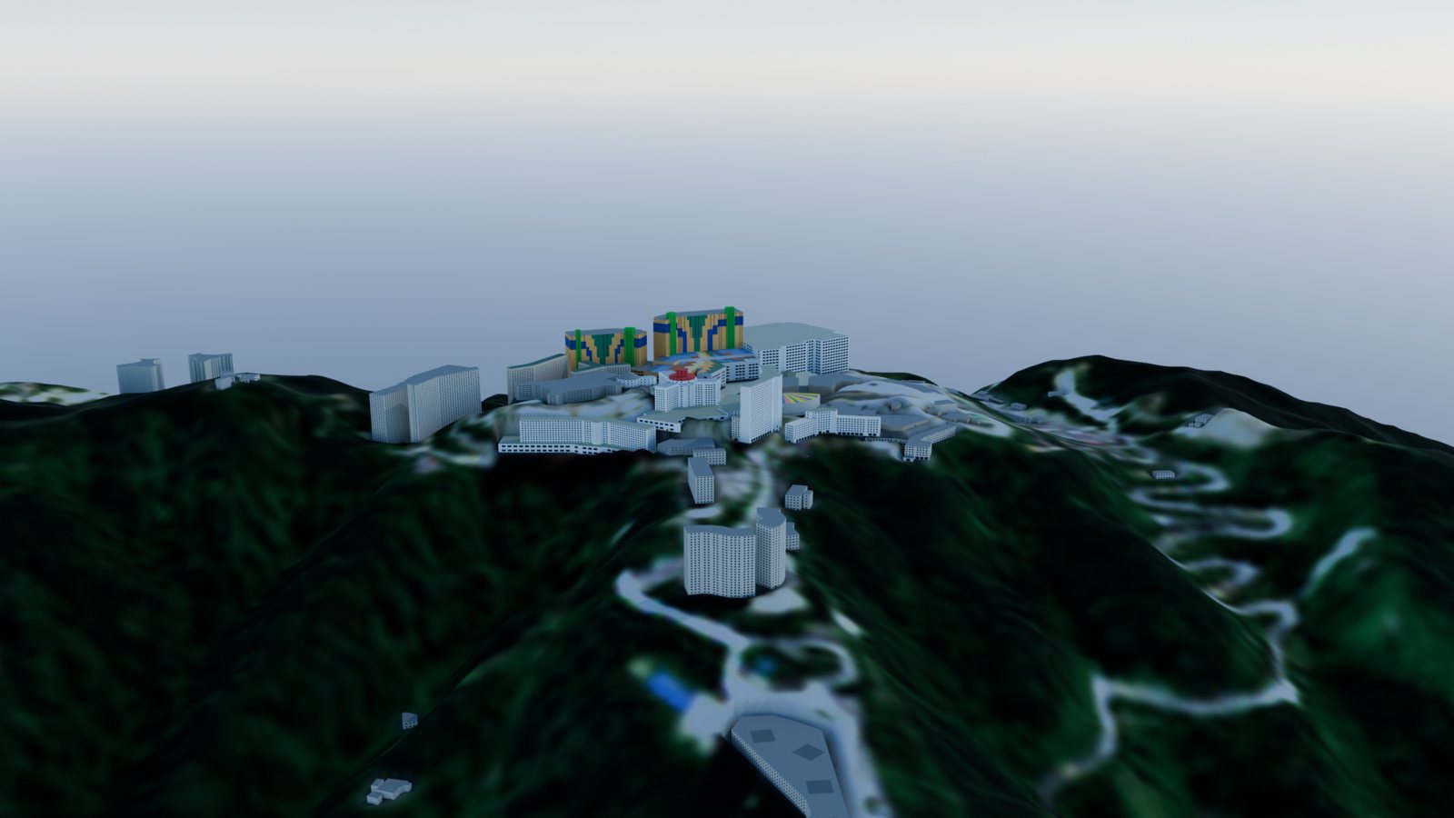 Aerial view from the south-west over forested slopes to the hilltop resort